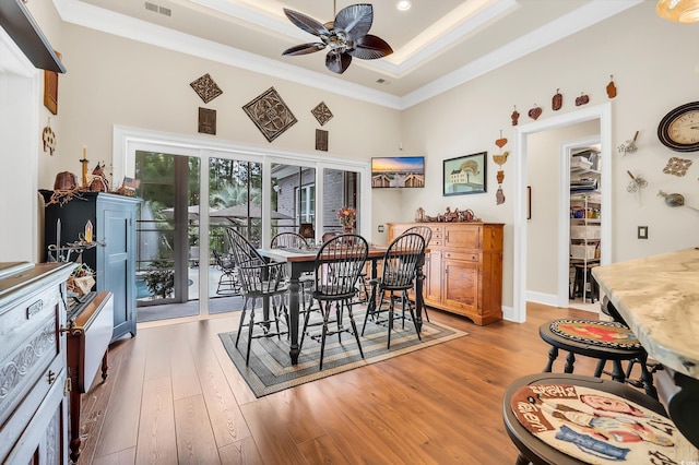81 Cascade Dr, Murrells Inlet, SC 29576 - dining room featuring a ceiling fan, wood finished floors, ornamental molding, a towering ceiling, and a raised ceiling