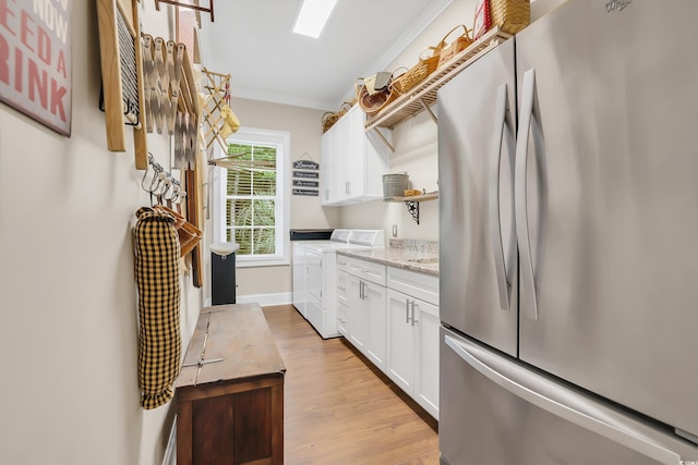 81 Cascade Dr, Murrells Inlet, SC 29576 - kitchen featuring freestanding refrigerator, open shelves, washer and clothes dryer, white cabinetry, and light wood-type flooring