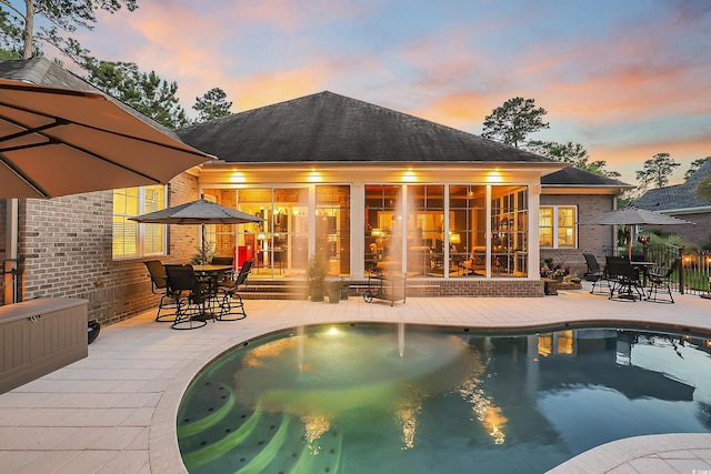 81 Cascade Dr, Murrells Inlet, SC 29576 - rear view of property with a patio, an outdoor pool, brick siding, and outdoor dining space