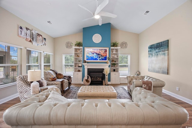 2300 Lark Sparrow St, Myrtle Beach, SC 29577 - living room featuring dark wood-style floors, baseboards, high vaulted ceiling, ceiling fan, and a glass covered fireplace