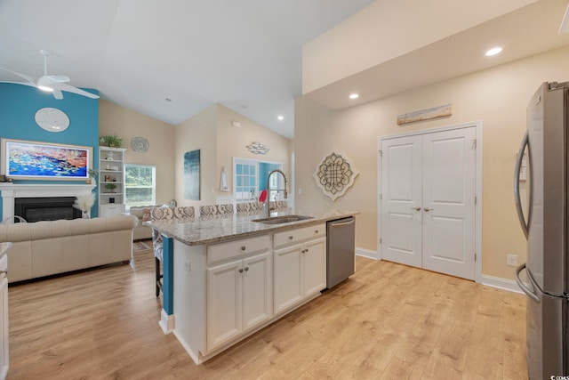 2300 Lark Sparrow St, Myrtle Beach, SC 29577 - kitchen with a sink, appliances with stainless steel finishes, a ceiling fan, white cabinetry, and light stone countertops