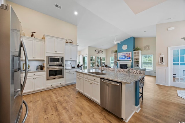 2300 Lark Sparrow St, Myrtle Beach, SC 29577 - kitchen featuring appliances with stainless steel finishes, a sink, ceiling fan, a fireplace, and open floor plan