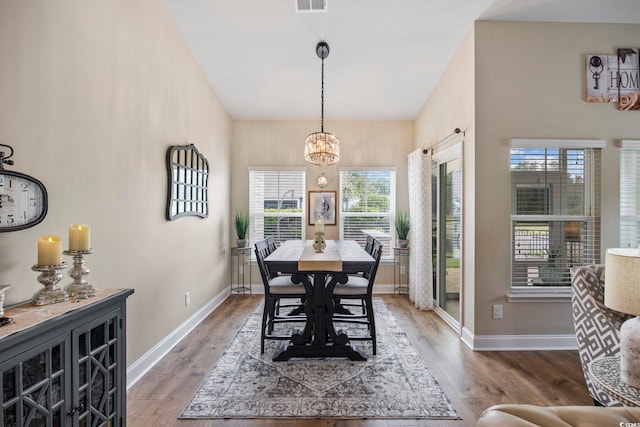 2300 Lark Sparrow St, Myrtle Beach, SC 29577 - dining space featuring healthy amount of natural light, a chandelier, wood finished floors, baseboards, and a high ceiling