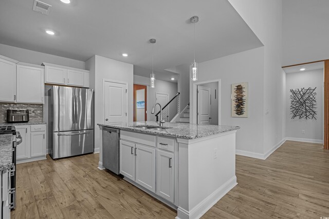 1168 Baker Creek Loop, Myrtle Beach, SC 29579 - kitchen featuring stainless steel appliances, a sink, light wood-style flooring, white cabinets, and recessed lighting