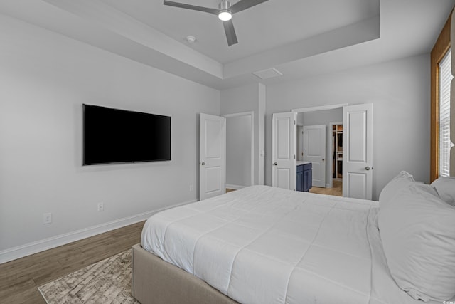 1168 Baker Creek Loop, Myrtle Beach, SC 29579 - bedroom featuring wood finished floors, baseboards, a raised ceiling, and a ceiling fan