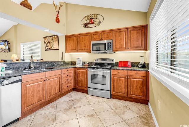 201 Westleton Dr Unit 10-I, Myrtle Beach, SC 29572 - kitchen with stainless steel appliances, a sink, brown cabinets, and high vaulted ceiling