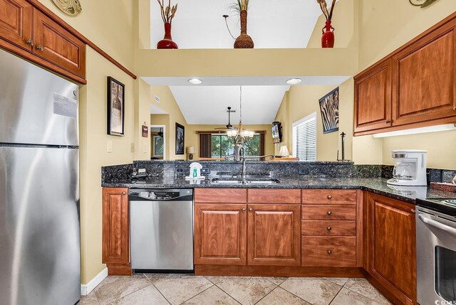 201 Westleton Dr Unit 10-I, Myrtle Beach, SC 29572 - kitchen featuring appliances with stainless steel finishes, a sink, dark stone counters, brown cabinetry, and decorative light fixtures
