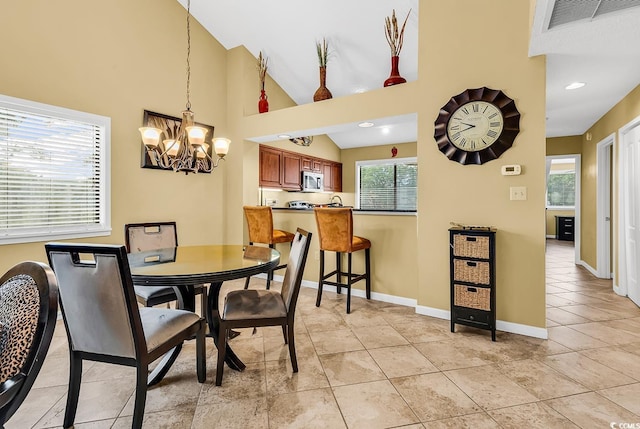 201 Westleton Dr Unit 10-I, Myrtle Beach, SC 29572 - dining space featuring a chandelier, healthy amount of natural light, baseboards, light tile patterned floors, and a high ceiling