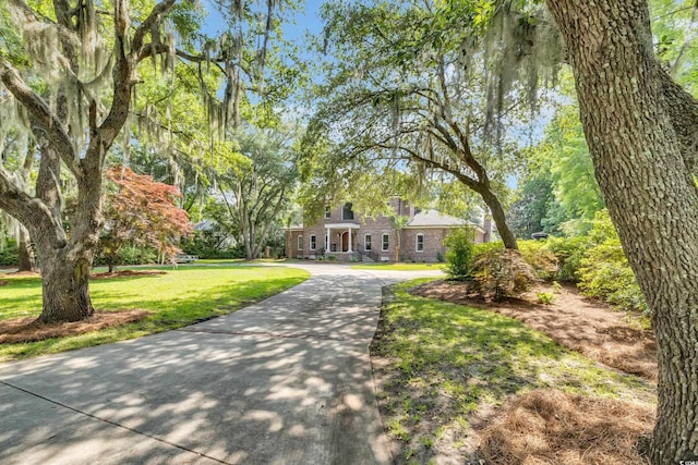 2382 Waverly Rd, Pawleys Island, SC 29585 - view of front of home featuring a front yard, brick siding, and driveway