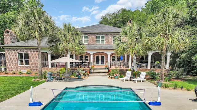 2382 Waverly Rd, Pawleys Island, SC 29585 - back of property featuring brick siding, a patio area, french doors, an outdoor pool, and a shingled roof