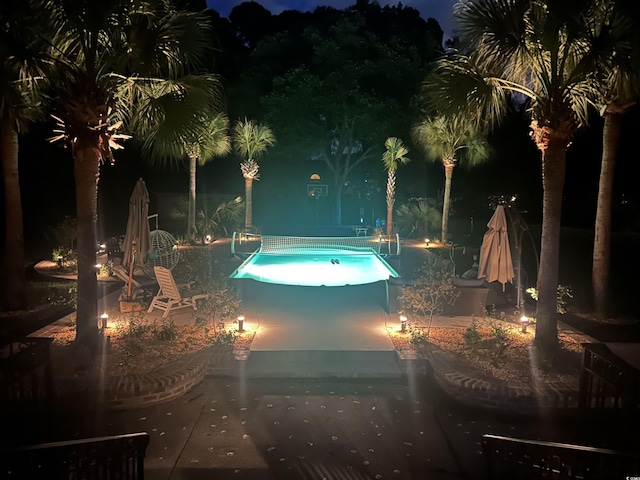 2382 Waverly Rd, Pawleys Island, SC 29585 - pool at night with a patio area and a community pool