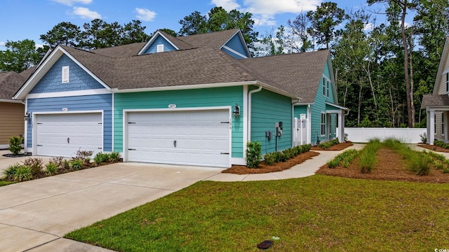 2475 Blue Crane Cir Unit 106, Myrtle Beach, SC 29577 - view of front of property with an attached garage, driveway, roof with shingles, and a front yard