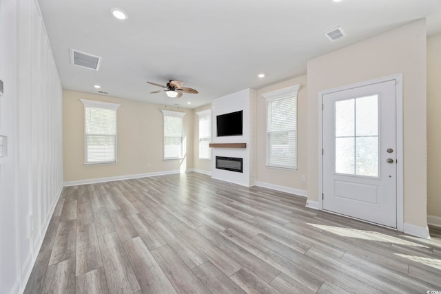 2475 Blue Crane Cir Unit 106, Myrtle Beach, SC 29577 - unfurnished living room featuring light wood-type flooring, ceiling fan, a fireplace, recessed lighting, and baseboards