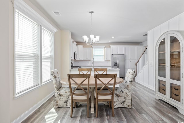 2475 Blue Crane Cir Unit 106, Myrtle Beach, SC 29577 - dining room with a chandelier, wood finished floors, baseboards, stairs, and recessed lighting