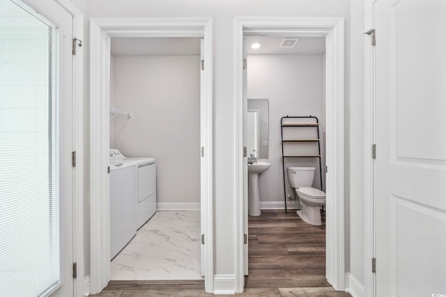 2475 Blue Crane Cir Unit 106, Myrtle Beach, SC 29577 - bathroom featuring separate washer and dryer, toilet, baseboards, marble look tiles, and a closet