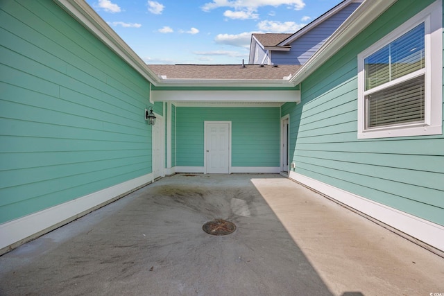 2475 Blue Crane Cir Unit 106, Myrtle Beach, SC 29577 - view of exterior entry featuring a patio area and a shingled roof