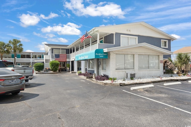 5409 N Ocean Blvd Unit 106/7 108, North Myrtle Beach, SC 29582 - view of building exterior with uncovered parking