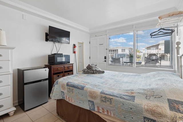 5409 N Ocean Blvd Unit 106/7 108, North Myrtle Beach, SC 29582 - bedroom featuring freestanding refrigerator, crown molding, and light tile patterned floors