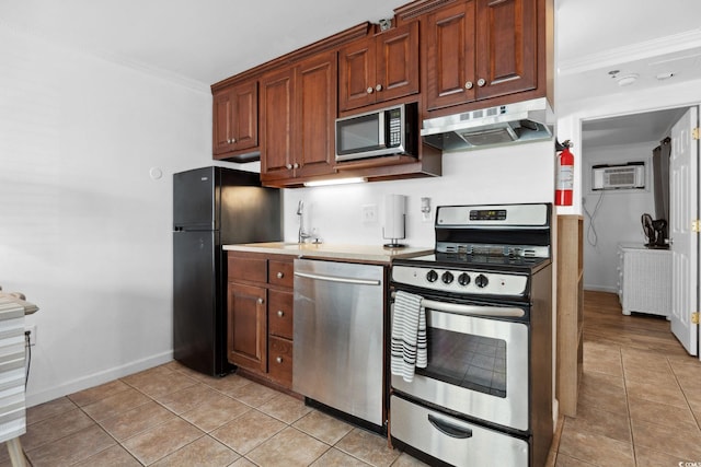 5409 N Ocean Blvd Unit 106/7 108, North Myrtle Beach, SC 29582 - kitchen with stainless steel appliances, under cabinet range hood, light tile patterned floors, baseboards, and crown molding