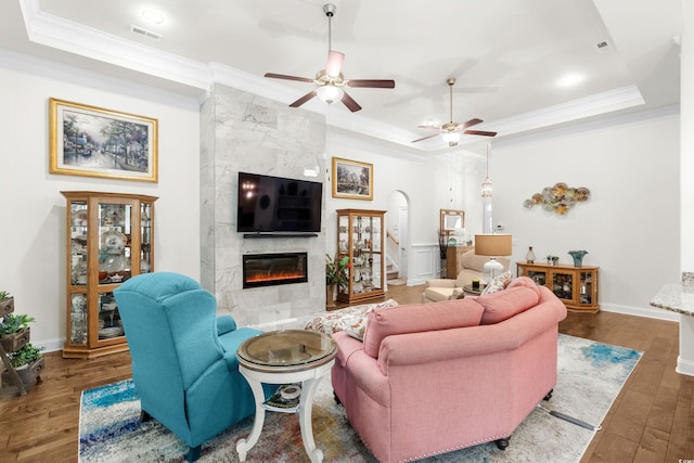 2318 Via Palma Dr, North Myrtle Beach, SC 29582 - living area with a premium fireplace, a raised ceiling, wood-type flooring, ornamental molding, and stairway