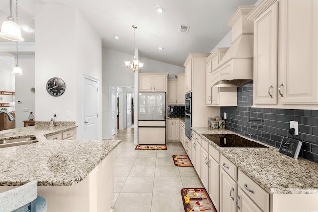 2318 Via Palma Dr, North Myrtle Beach, SC 29582 - kitchen with freestanding refrigerator, black electric stovetop, a sink, premium range hood, and double oven