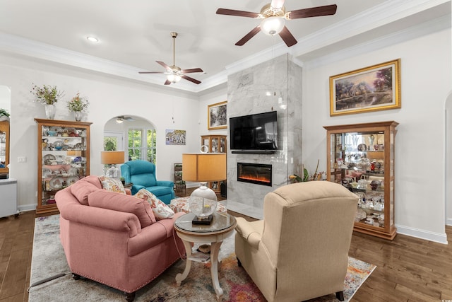 2318 Via Palma Dr, North Myrtle Beach, SC 29582 - living room featuring arched walkways, a ceiling fan, crown molding, a fireplace, and baseboards