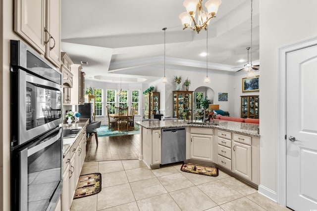 2318 Via Palma Dr, North Myrtle Beach, SC 29582 - kitchen with appliances with stainless steel finishes, a tray ceiling, a sink, a chandelier, and open floor plan