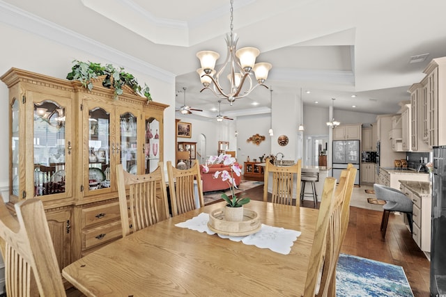 2318 Via Palma Dr, North Myrtle Beach, SC 29582 - dining area featuring a raised ceiling, a chandelier, a ceiling fan, crown molding, and dark wood-style floors