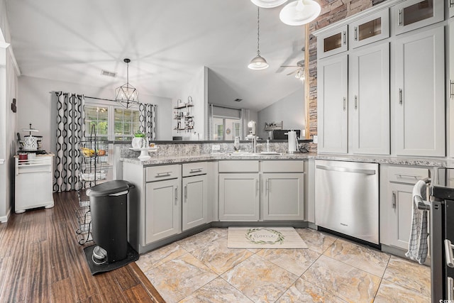 7007 Blade Beak Ln, Myrtle Beach, SC 29588 - kitchen featuring stainless steel dishwasher, a peninsula, vaulted ceiling, decorative light fixtures, and gray cabinetry