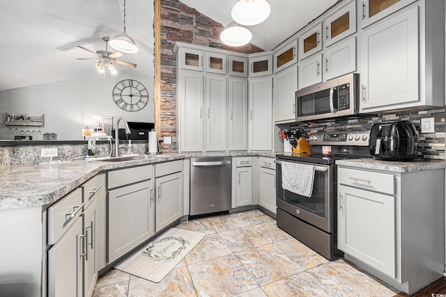 7007 Blade Beak Ln, Myrtle Beach, SC 29588 - kitchen featuring stainless steel appliances, vaulted ceiling, a peninsula, tasteful backsplash, and a ceiling fan