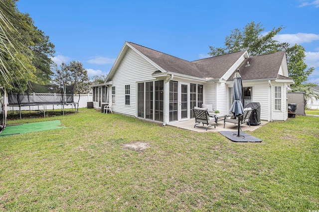 7007 Blade Beak Ln, Myrtle Beach, SC 29588 - back of house with a trampoline, a patio, a lawn, a sunroom, and a shingled roof