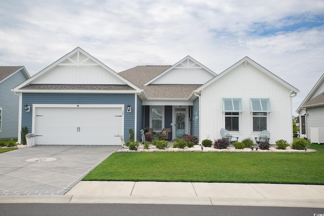 383 Mikita Dr, Surfside Beach, SC 29575 - view of front of property with a front lawn, a garage, driveway, a shingled roof, and covered porch