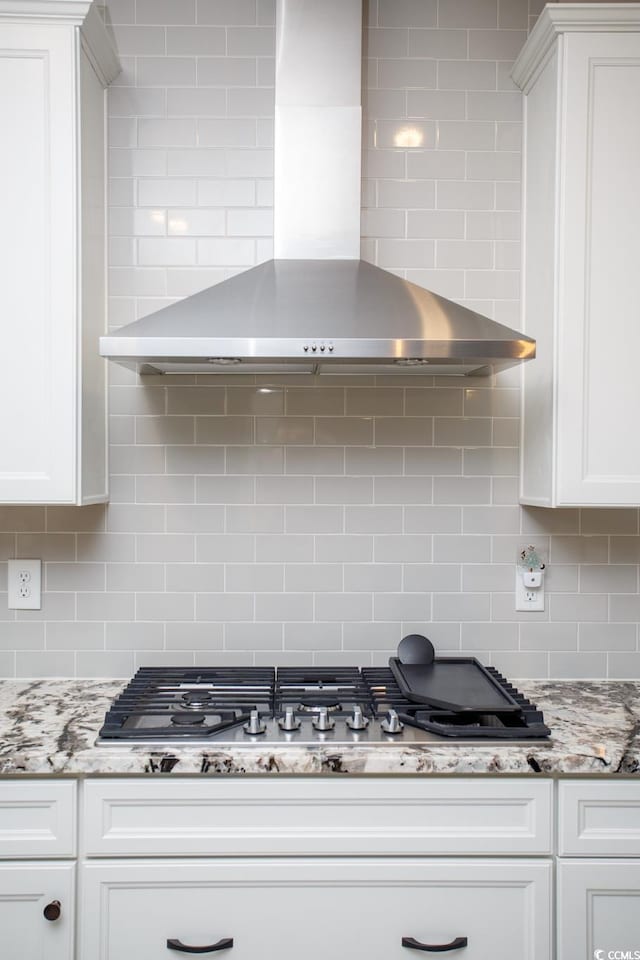 383 Mikita Dr, Surfside Beach, SC 29575 - kitchen featuring wall chimney range hood, decorative backsplash, white cabinets, and stainless steel gas stovetop