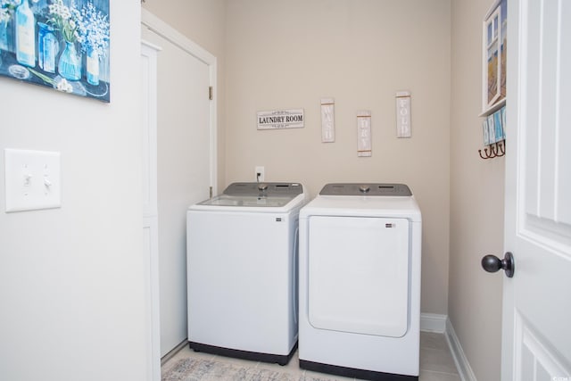 383 Mikita Dr, Surfside Beach, SC 29575 - washroom featuring washing machine and dryer, light tile patterned flooring, and baseboards