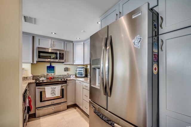 1990 N Waccamaw Dr Unit 1008, Murrells Inlet, SC 29576 - kitchen with stainless steel appliances, light stone counters, gray cabinetry, recessed lighting, and light tile patterned flooring