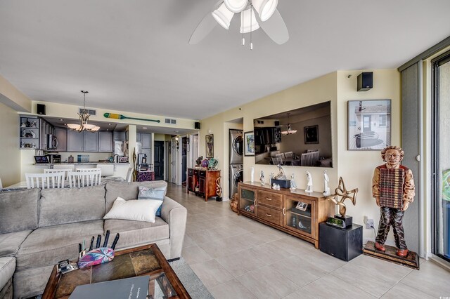 1990 N Waccamaw Dr Unit 1008, Murrells Inlet, SC 29576 - living area featuring stacked washer and clothes dryer, a chandelier, a ceiling fan, and light tile patterned floors