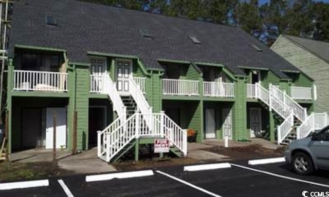 411 Cambridge Cir Unit D4, Murrells Inlet, SC 29576 - view of building exterior featuring stairway and uncovered parking