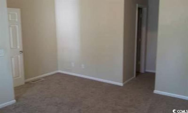 411 Cambridge Cir Unit D4, Murrells Inlet, SC 29576 - spare room with baseboards and dark carpet