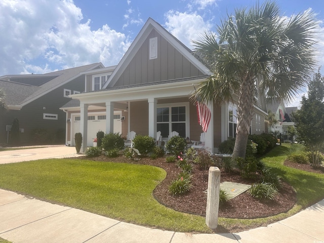 1145 Captain Hooks Way N, Myrtle Beach, SC 29582 - craftsman-style house featuring board and batten siding, a porch, a garage, a front yard, and concrete driveway