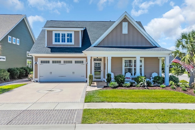 1145 Captain Hooks Way N, Myrtle Beach, SC 29582 - view of front of house featuring board and batten siding, covered porch, concrete driveway, and roof with shingles