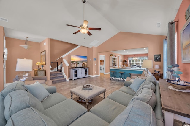 1145 Captain Hooks Way N, Myrtle Beach, SC 29582 - living room with wood finished floors, ceiling fan, stairway, washer / clothes dryer, and high vaulted ceiling