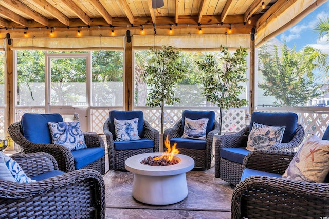 1145 Captain Hooks Way N, Myrtle Beach, SC 29582 - sunroom / solarium featuring rail lighting, plenty of natural light, beamed ceiling, and an outdoor living space with a fire pit