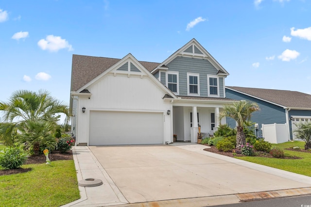 2572 Brescia St, Myrtle Beach, SC 29579 - view of front of property with concrete driveway, covered porch, a garage, and a shingled roof
