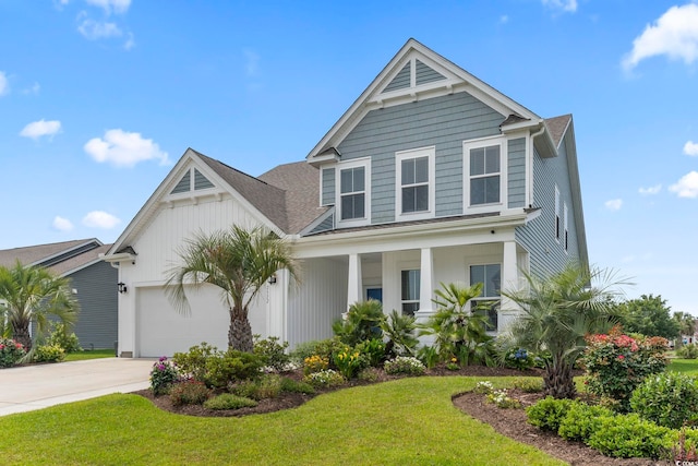 2572 Brescia St, Myrtle Beach, SC 29579 - view of front facade featuring driveway, an attached garage, a front yard, and a porch