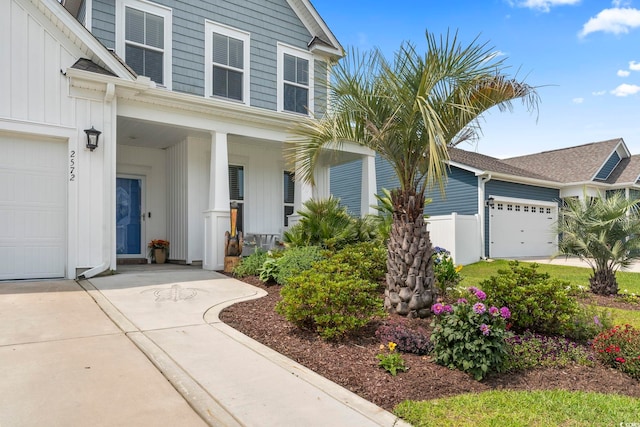 2572 Brescia St, Myrtle Beach, SC 29579 - view of front facade featuring board and batten siding, a porch, concrete driveway, and a garage