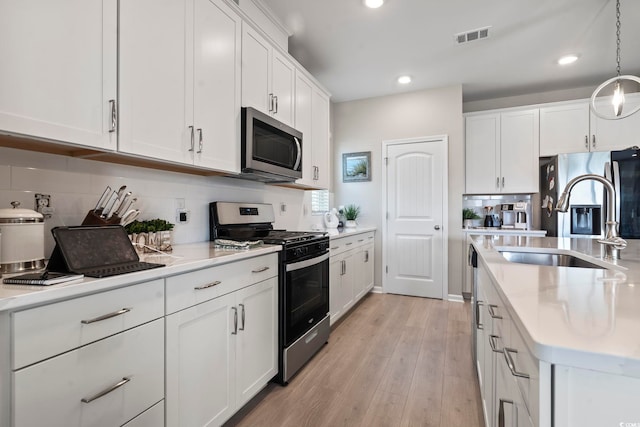 2572 Brescia St, Myrtle Beach, SC 29579 - kitchen featuring stainless steel appliances, tasteful backsplash, light countertops, white cabinets, and recessed lighting