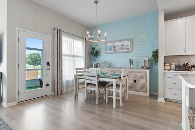 2572 Brescia St, Myrtle Beach, SC 29579 - dining space featuring a chandelier, light wood-type flooring, wood walls, and baseboards