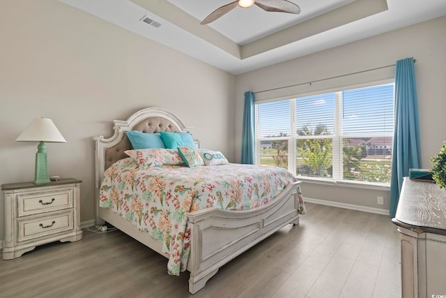 2572 Brescia St, Myrtle Beach, SC 29579 - bedroom featuring light wood-style floors, baseboards, a tray ceiling, and ceiling fan