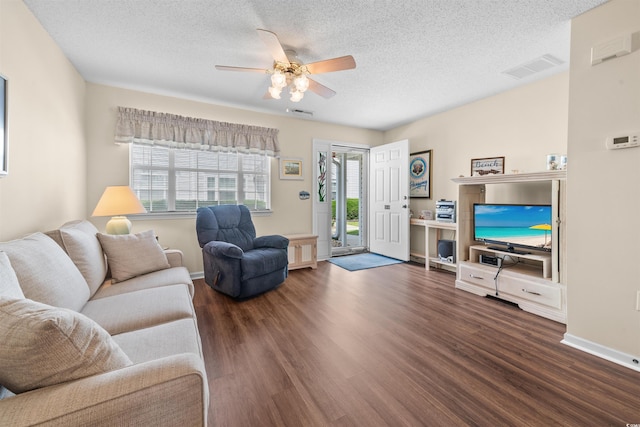 613 S 2nd Ave Unit 21D, North Myrtle Beach, SC 29582 - living room featuring ceiling fan, dark wood-style flooring, a textured ceiling, and baseboards