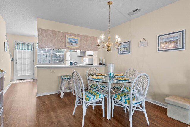 613 S 2nd Ave Unit 21D, North Myrtle Beach, SC 29582 - dining room with wood finished floors, a chandelier, and baseboards